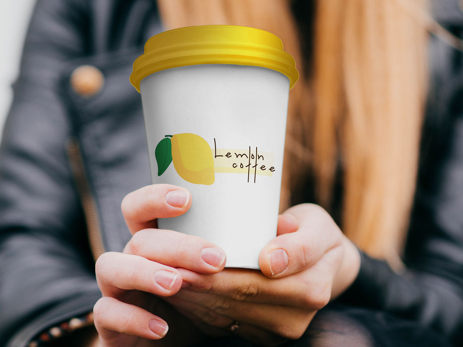 Free Paper Coffee Cup in hand Mockup PSD.jpg
