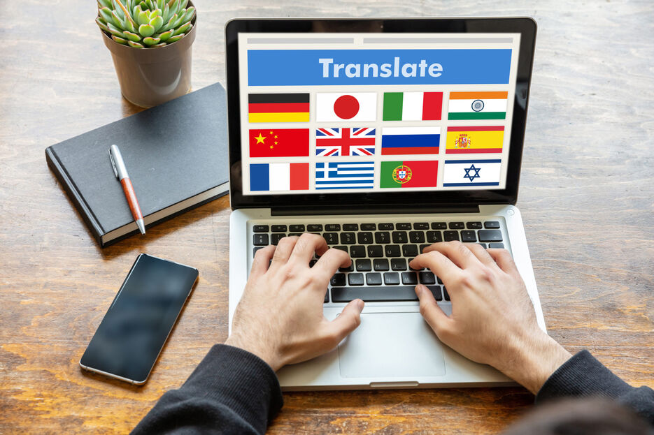 man-working-on-a-laptop-with-the-word-translate-on-J3A7WLH-1-scaled.jpg