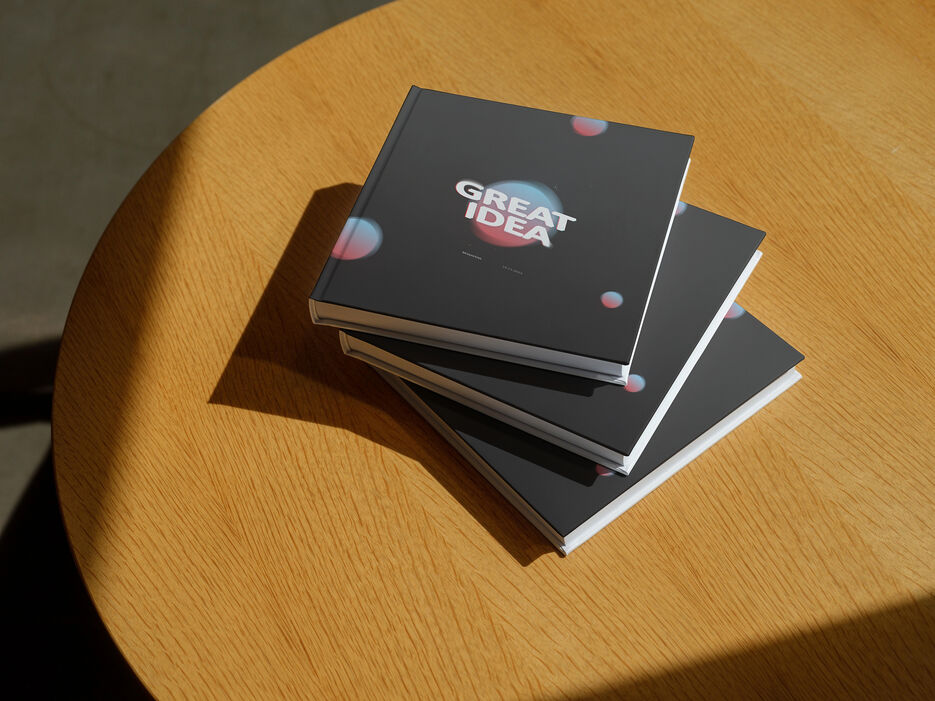 Mockup of stacked hardcover books on a wooden table (Mockuuups Studio).jpg